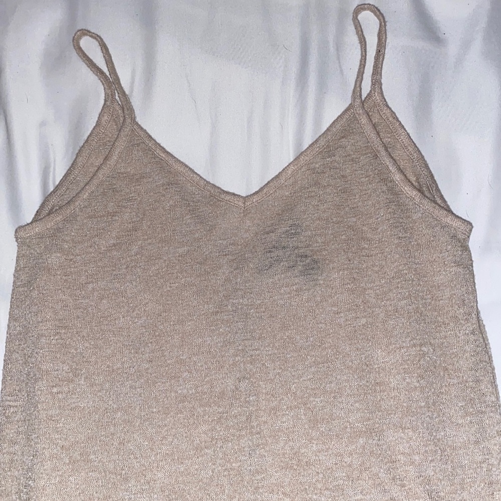 Slightly see through beige tank top.